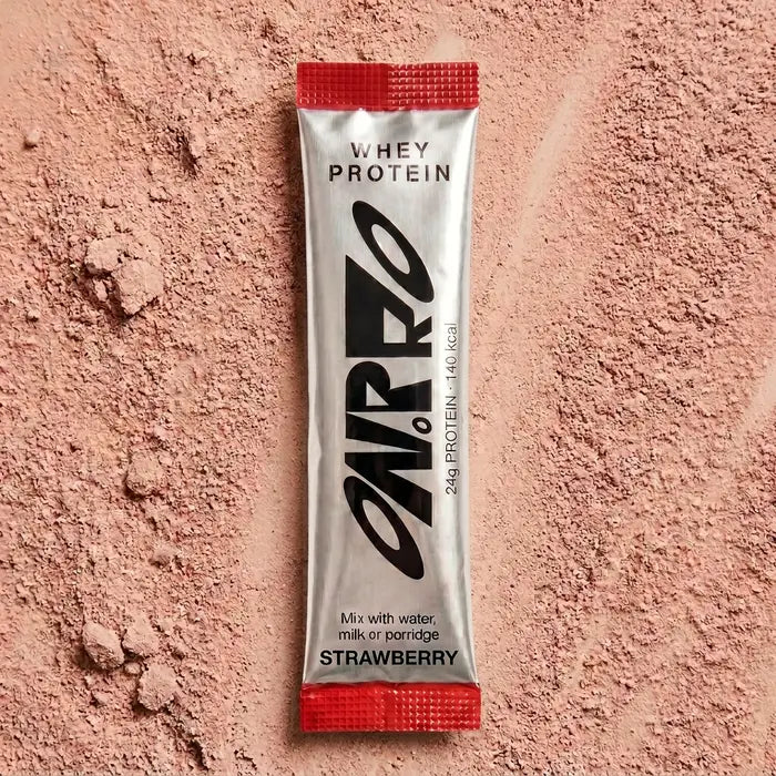 ON.PRO strawberry whey protein sachet on a bed of powder