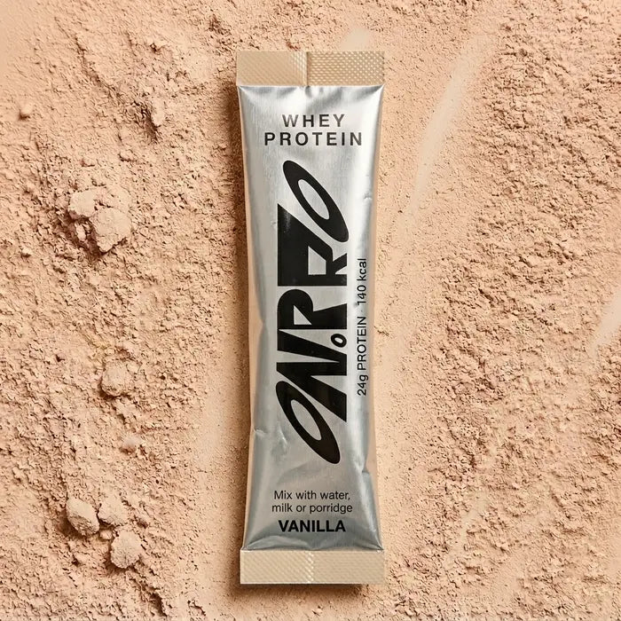 ON.PRO vanilla whey protein sachet on a bed of powder